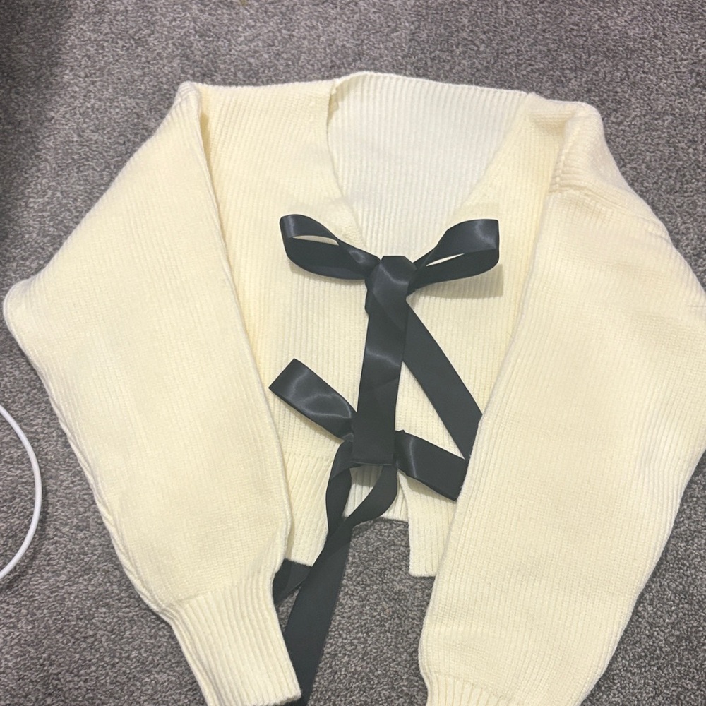 Elegant Cream Sweater with Black Ribbon Accents